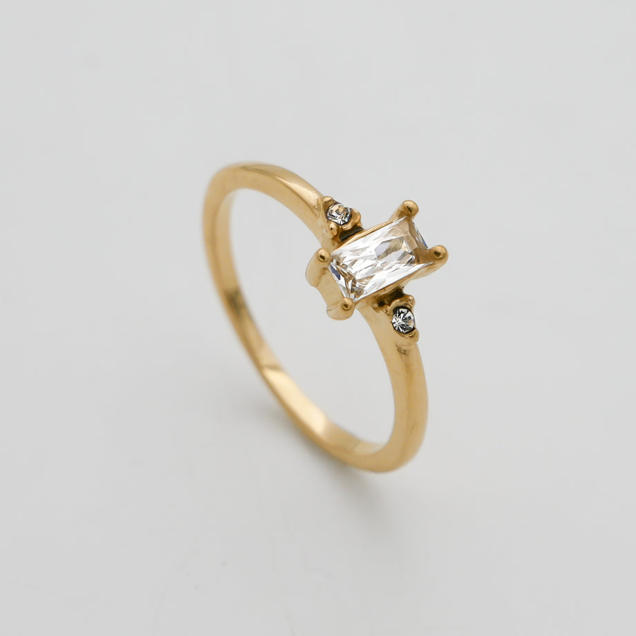 Gold ring with a rectangular diamond centrepiece.