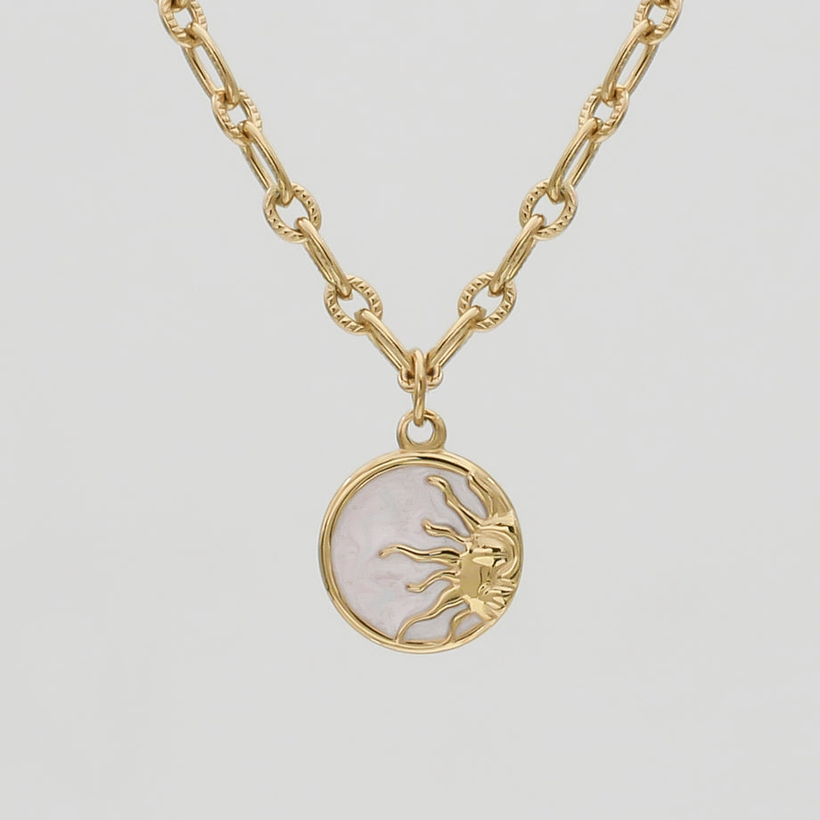 Gold necklace with a sun pendant.