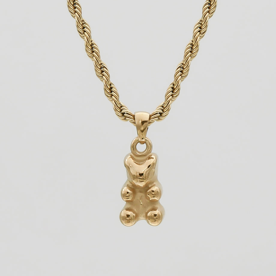 Gold gummy bear pendant on twisted chain necklace.