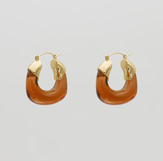 Amber Celine lucite hoop with an oval shape