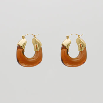 Amber Celine lucite hoop with an oval shape