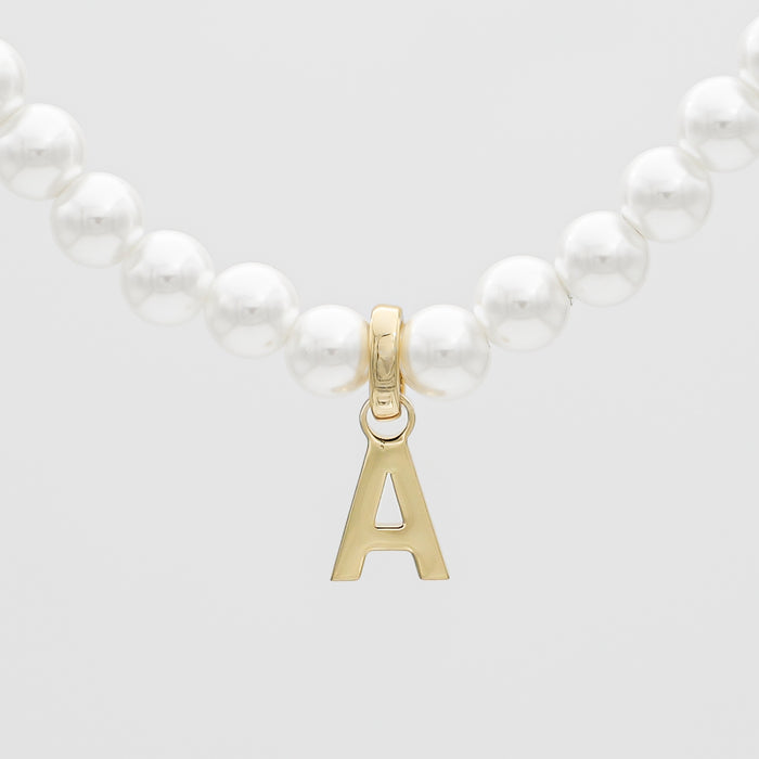 Pearl necklace with gold letter A pendant.