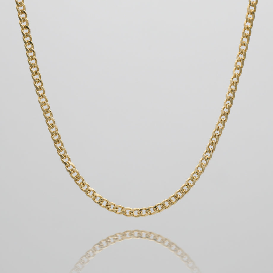 Gold Cuban pendant chain on white background.