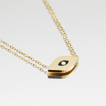 close up of Evil Eye necklace in Gold with black and white motif in the centre