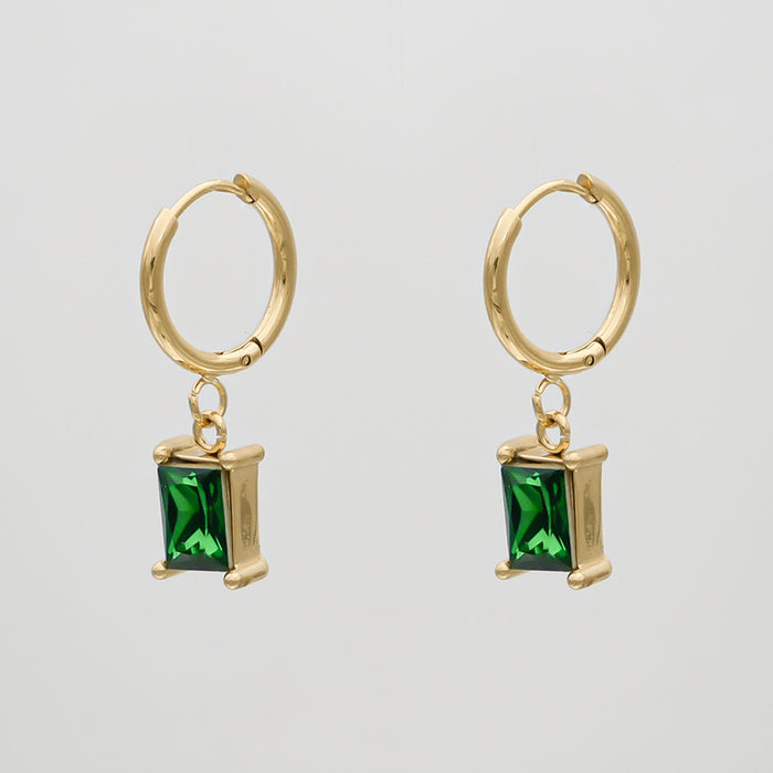 Gold hoop earrings with green gemstones.