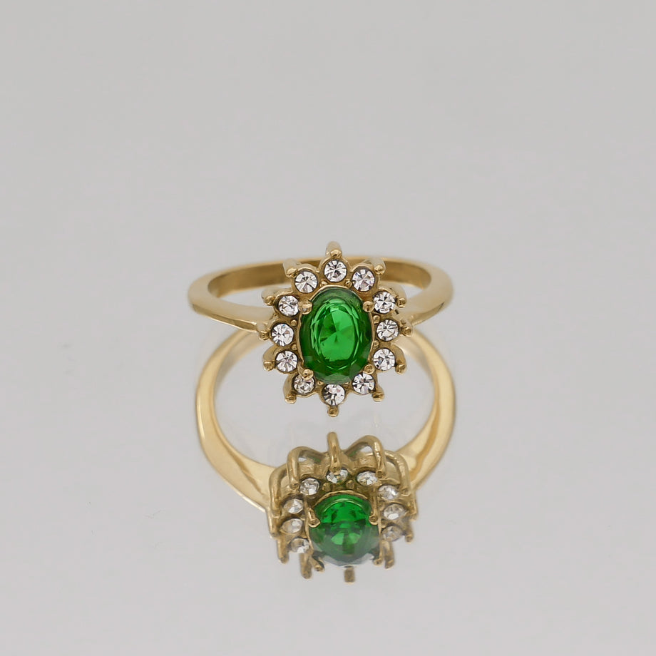 Gold ring with green gemstone and clear crystals.