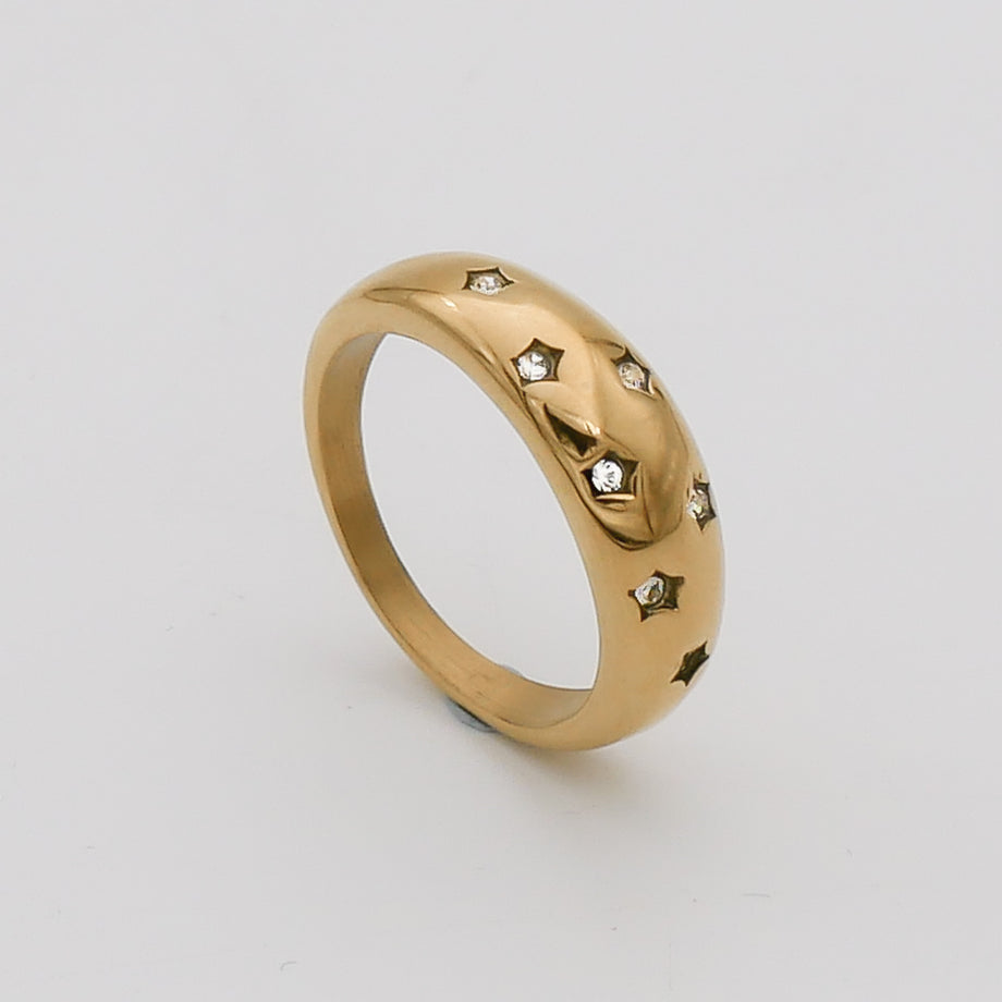 Gold ring with star engravings and small diamonds.