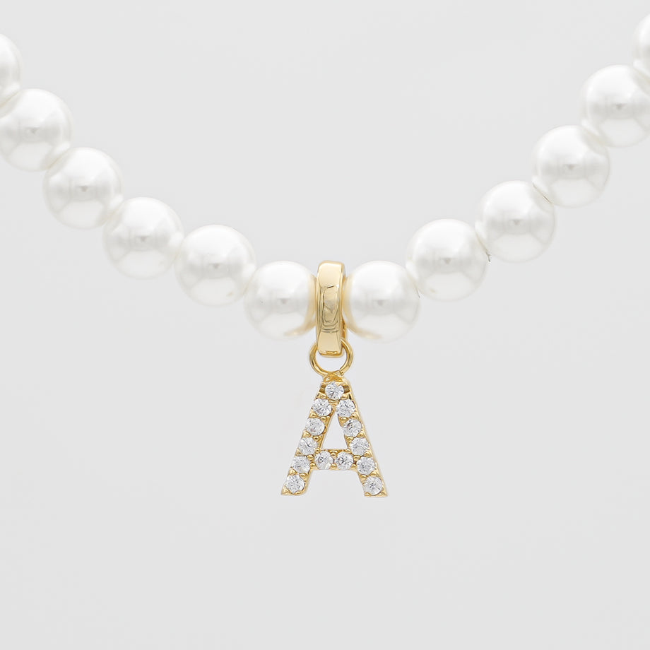 Pearl necklace with gold 'A' pendant.