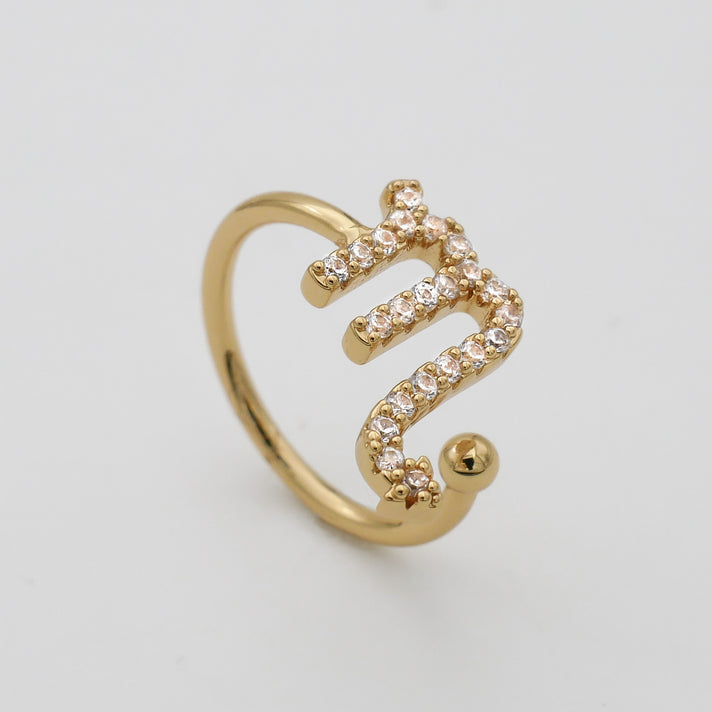 Gold ring with Scorpio zodiac symbol.