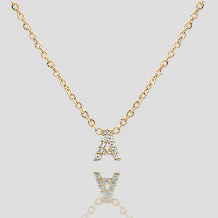 Gold necklace with diamond-studded "A" pendant.