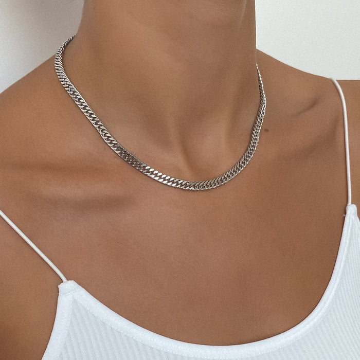 Woman wearing a silver chain necklace.