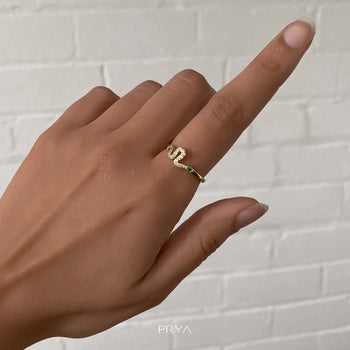 Model wearing the Paved Gold Taya Snake ring with emerald eyes