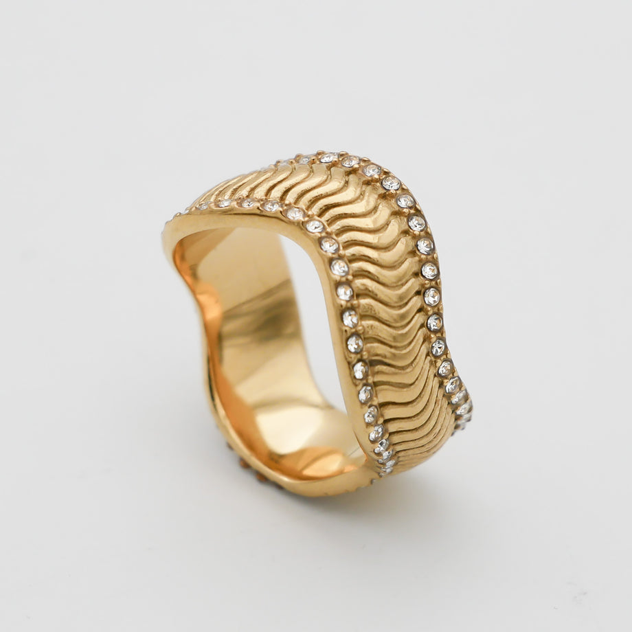 Gold ring with wavy design and diamonds.