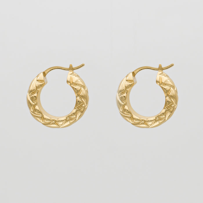 Gold hoop earrings with textured design.