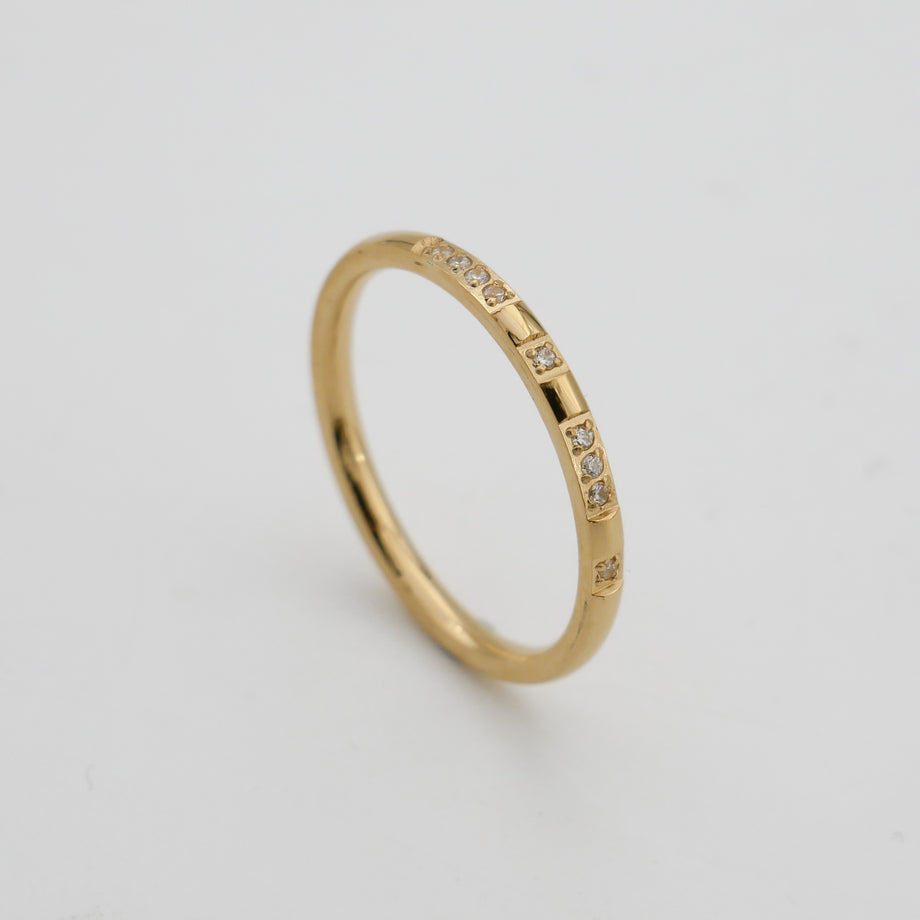 Gold ring with small cubic zirconia stones.