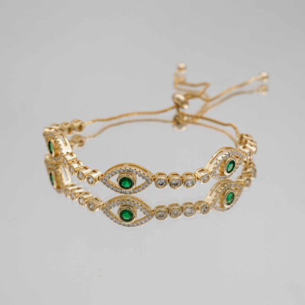 Gold Evil Suspended bracelet paved with CZ diamonds and Emerald Green Gem