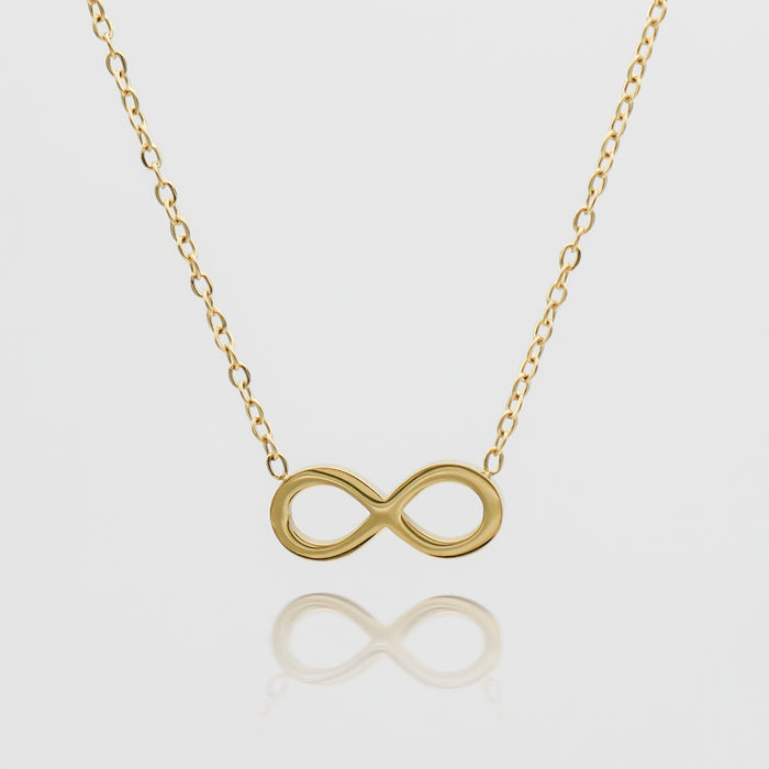 Gold infinity necklace on a delicate chain.