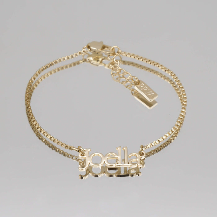 Gold custom name bracelet with "Joella".