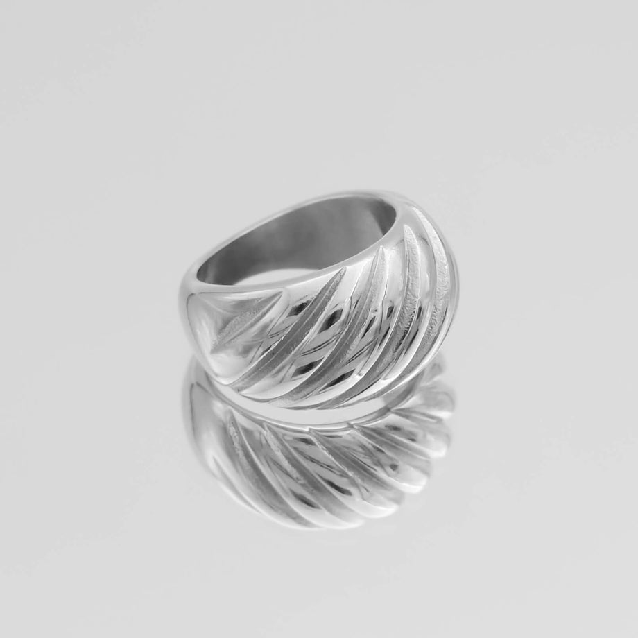 Silver ring with a textured, swirling design.