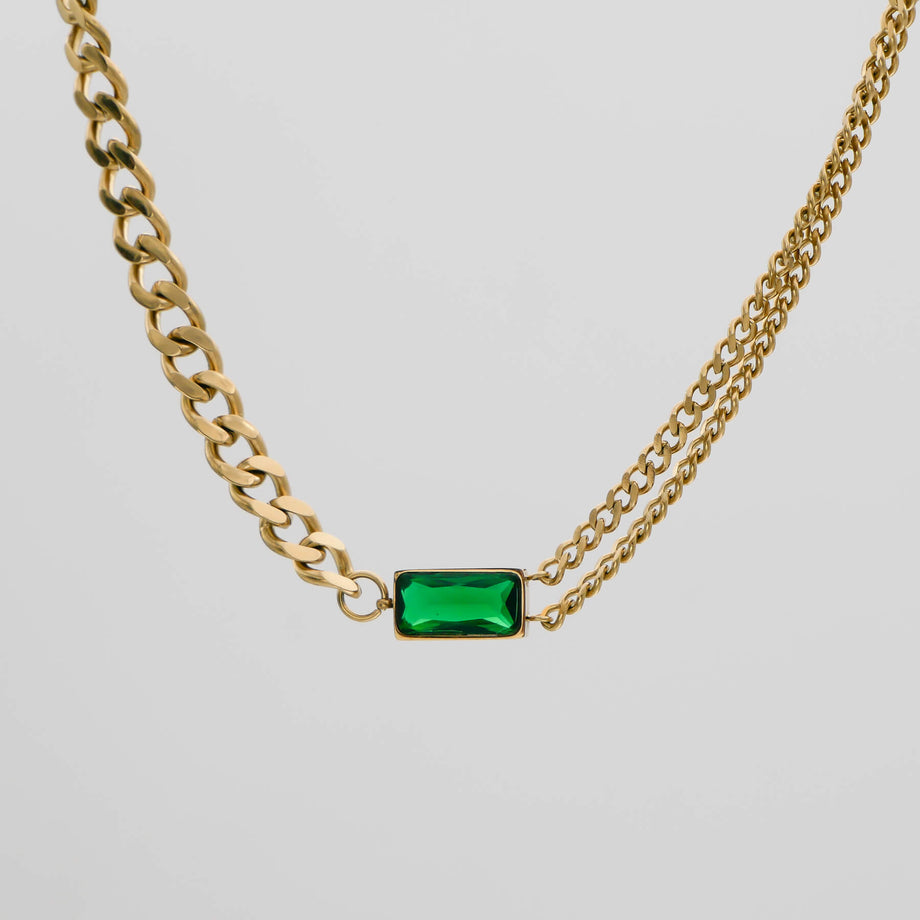 Gold chain necklace with green rectangular pendant.