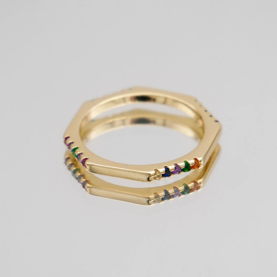 Gold hexagonal ring with colourful gemstones.