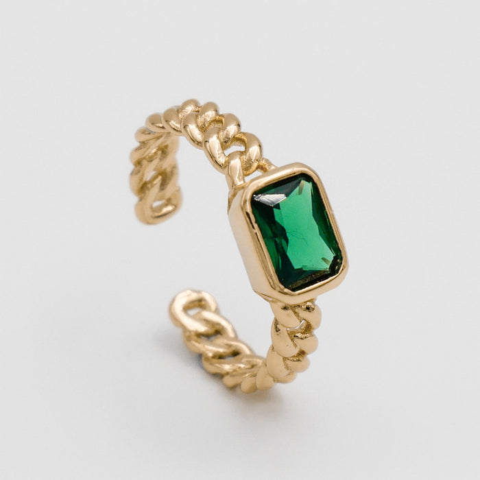 Gold ring with green gemstone.