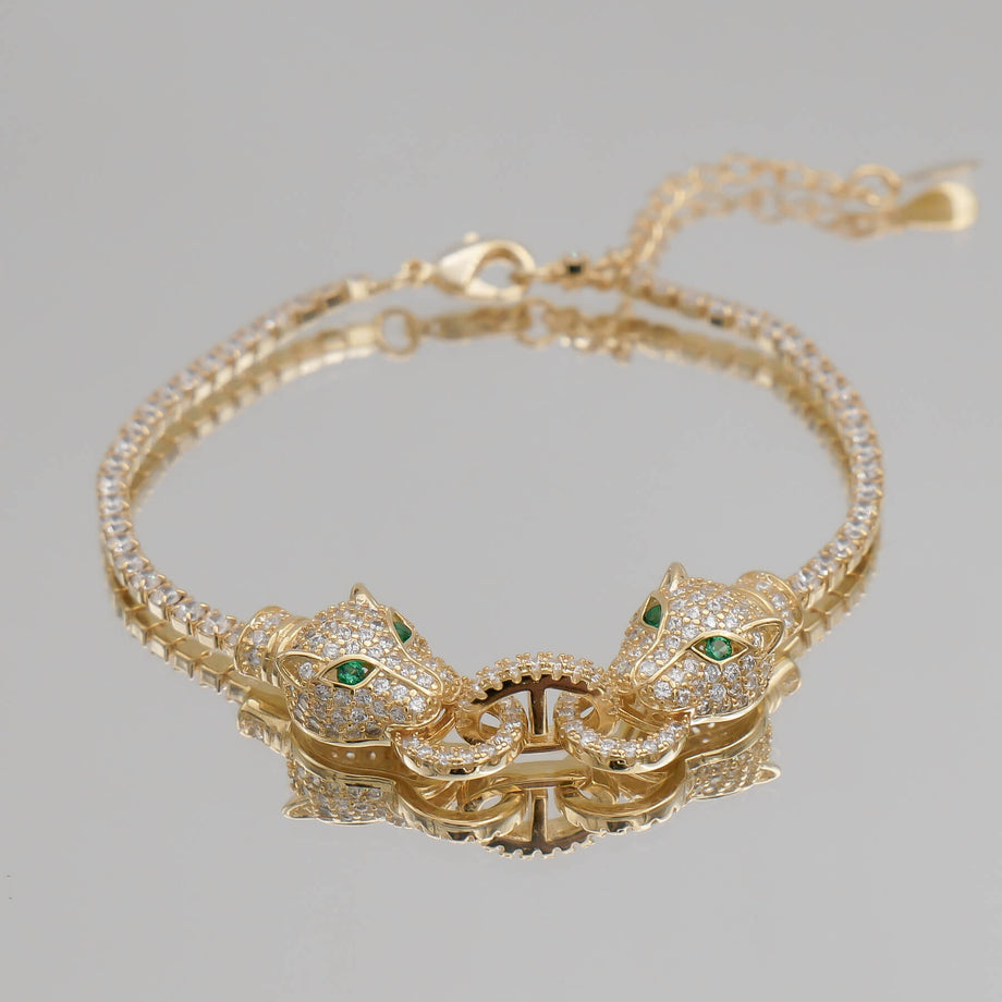 Gold bracelet with panther head design.