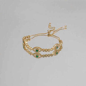 Gold Evil Suspended bracelet paved with CZ diamonds and Emerald Green Gem