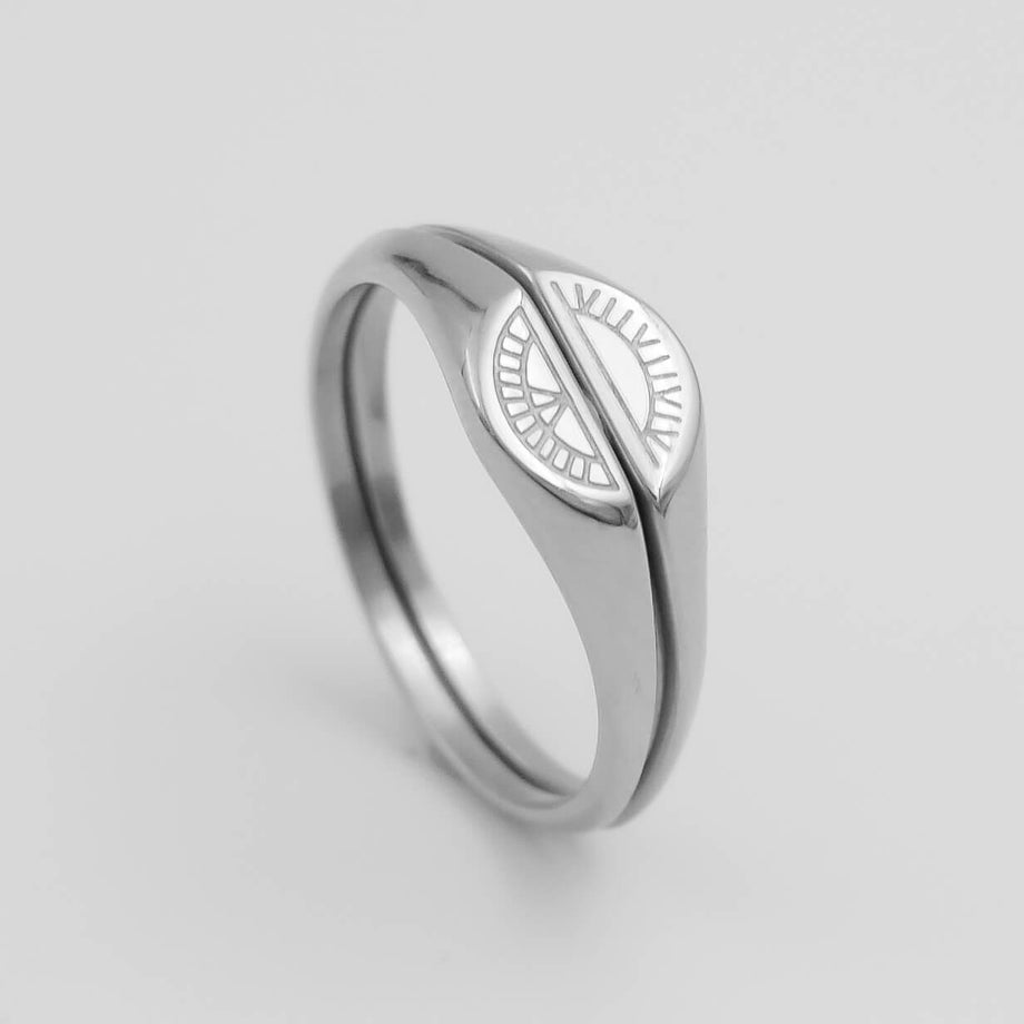 Silver ring with a sun and moon design.