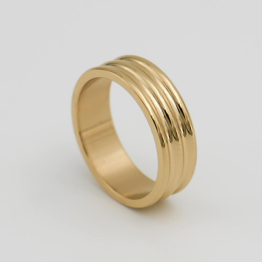 Gold ring with triple groove design.