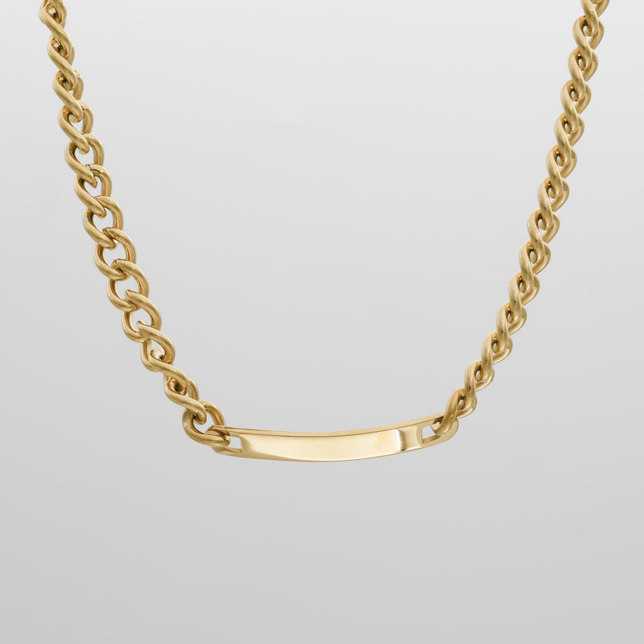 Gold chain necklace with a sleek bar pendant.