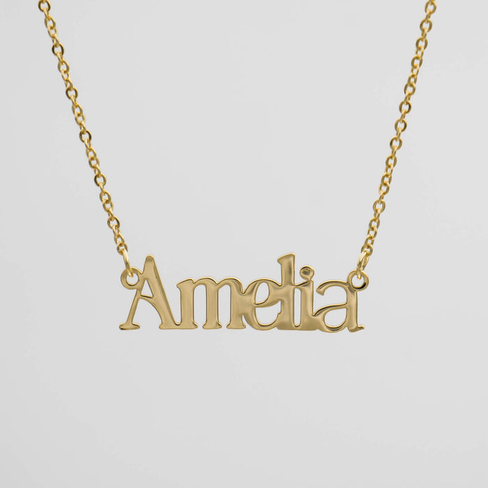 Gold necklace with "Amelia" name pendant.