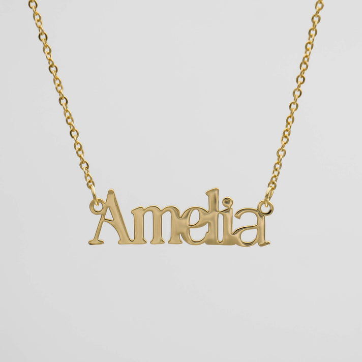 Gold necklace with "Amelia" name pendant.