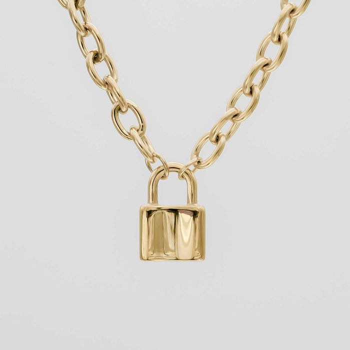 Gold chain necklace with padlock pendant.