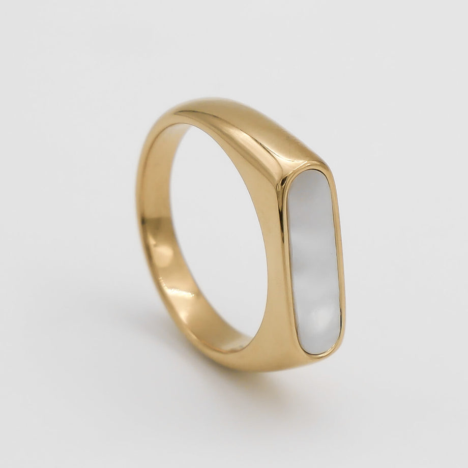 Gold ring with rectangular white stone.