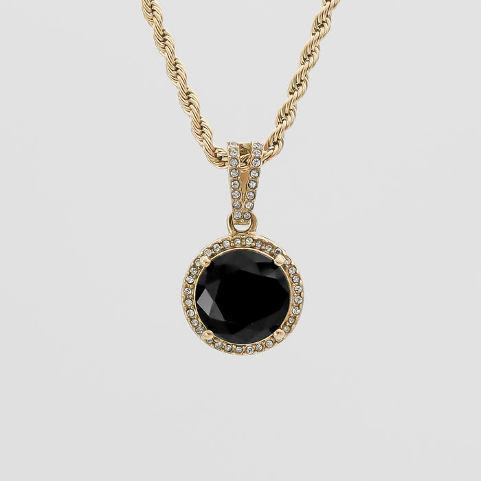 Gold necklace with black gemstone pendant.