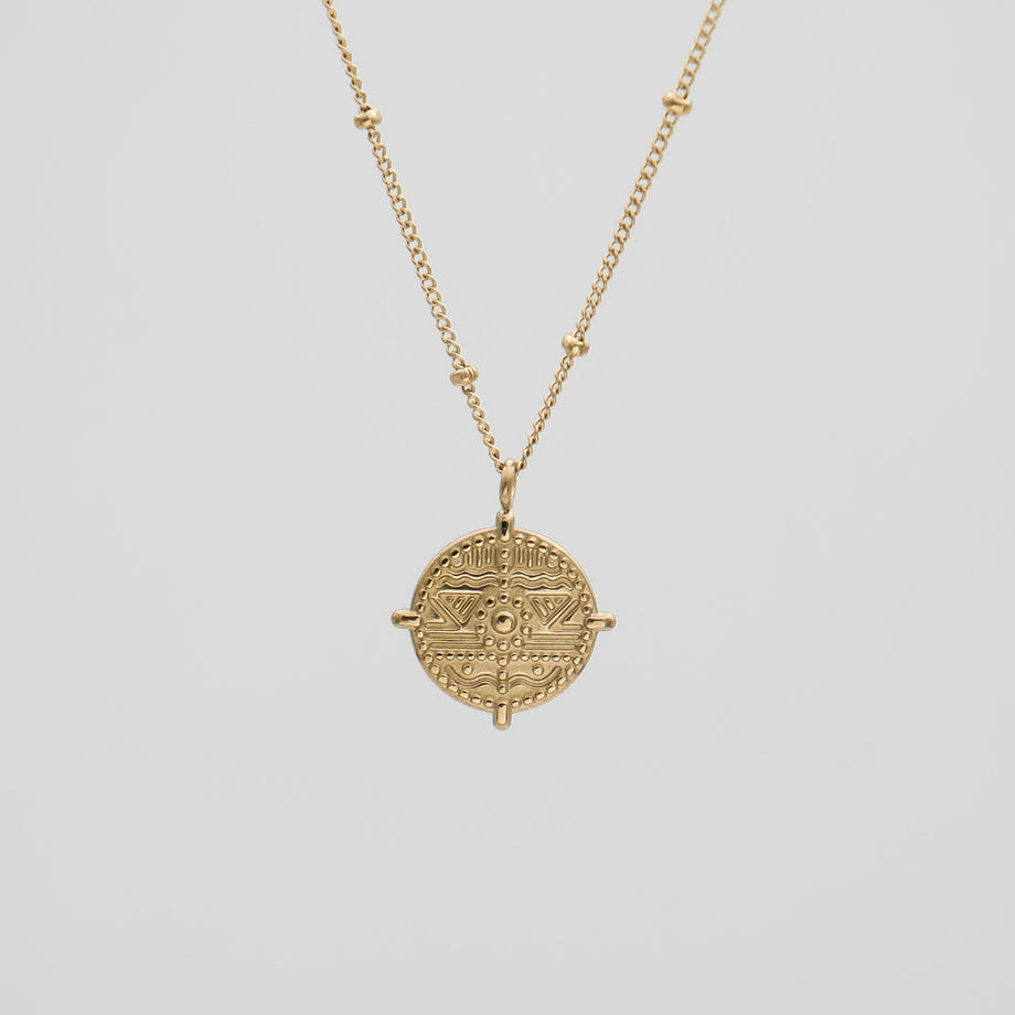 Gold coin pendant on a delicate chain.