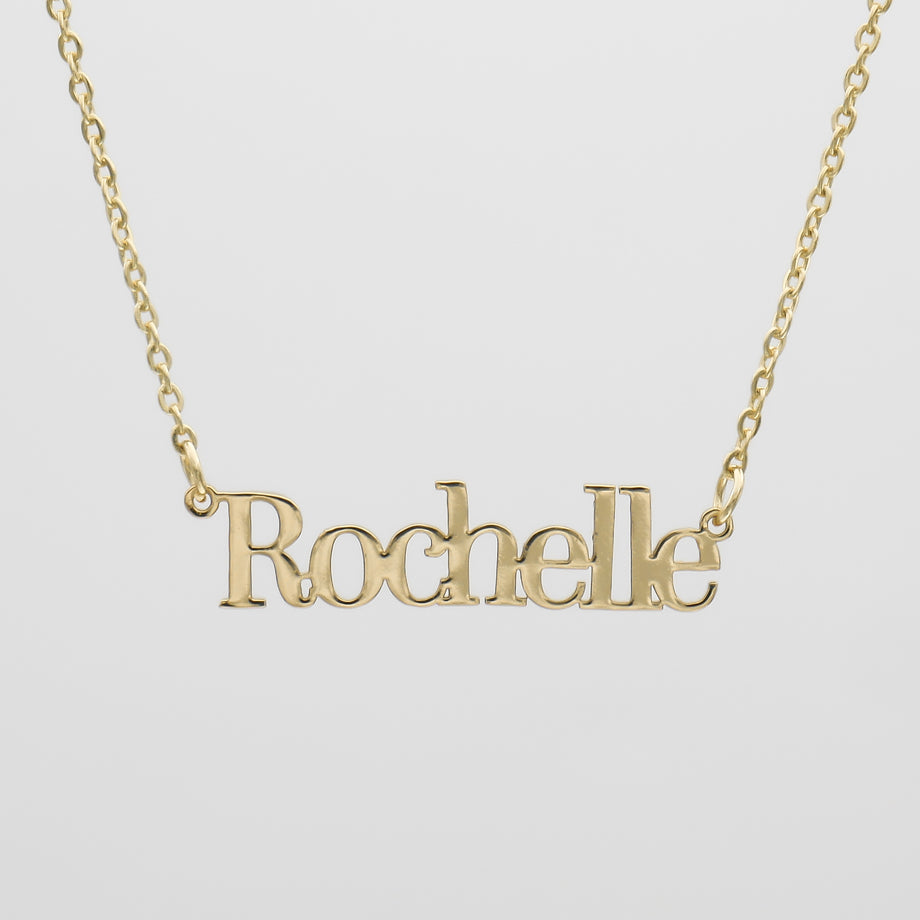 Gold necklace with "Rochelle" name pendant.