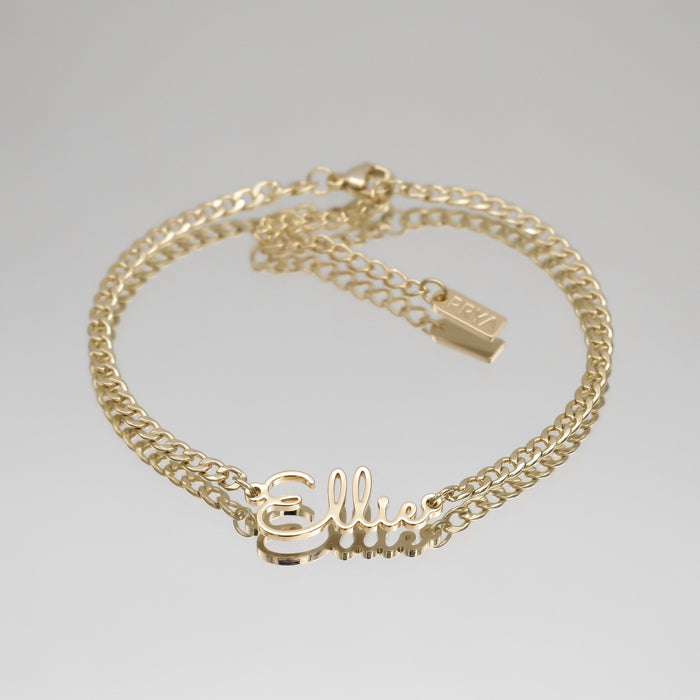 Gold anklet with "Ellie" nameplate.