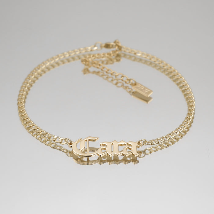 Gold anklet with "Cara" nameplate.