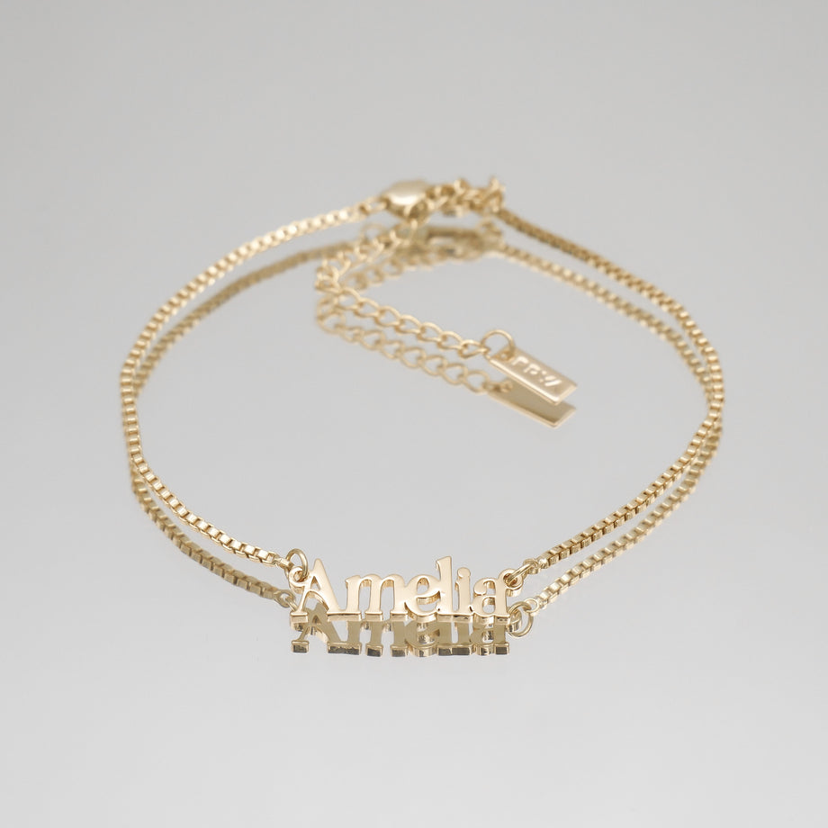 Gold anklet with "Amelia" nameplate.