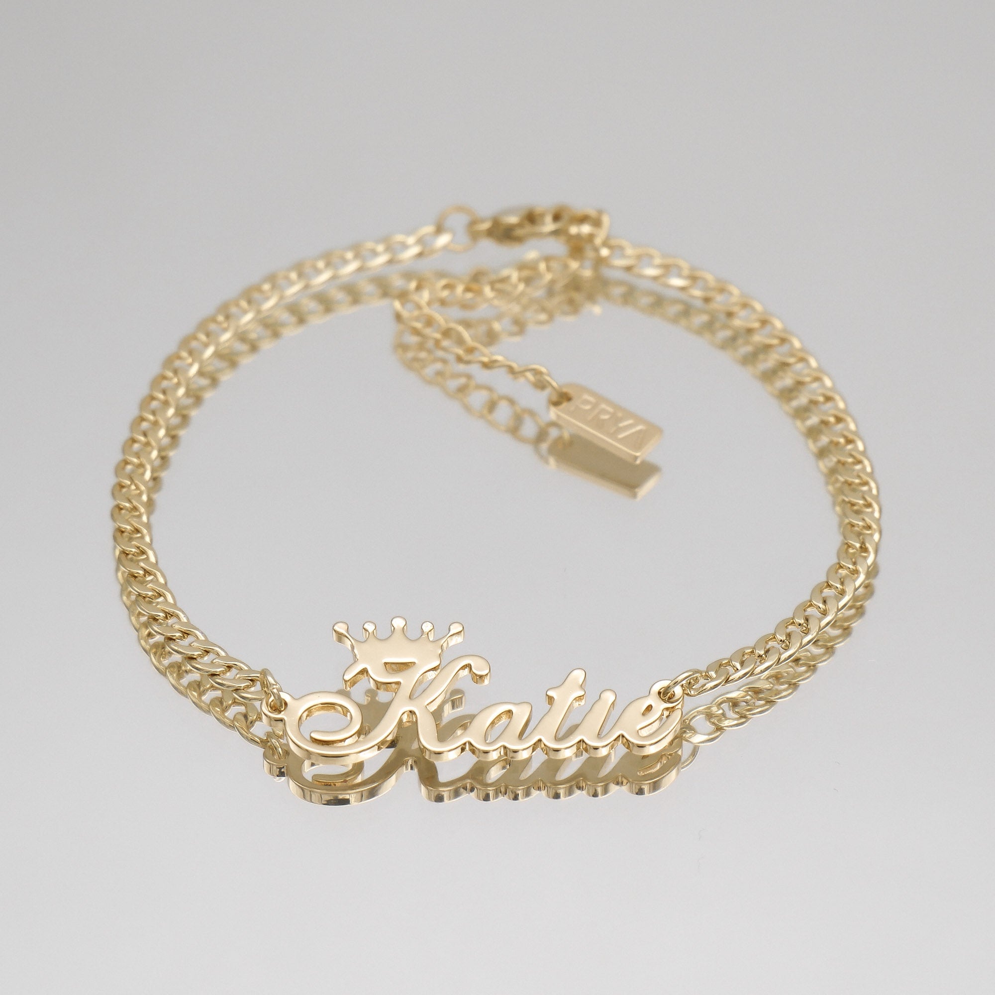Yellow gold personalised name anklet with Cuban link chain.