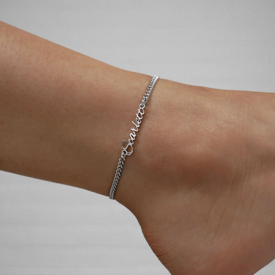 Silver Venice custom name anklet on an ankle