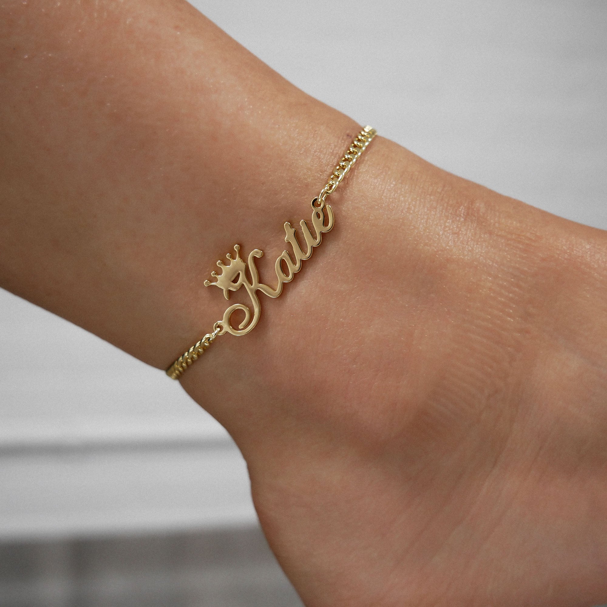 Gold Paris personalised name anklet on an ankle