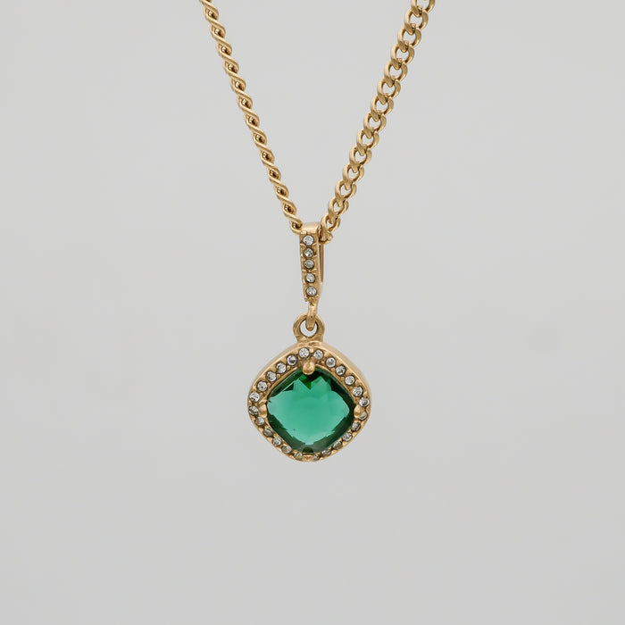 Gold necklace with green gemstone pendant.