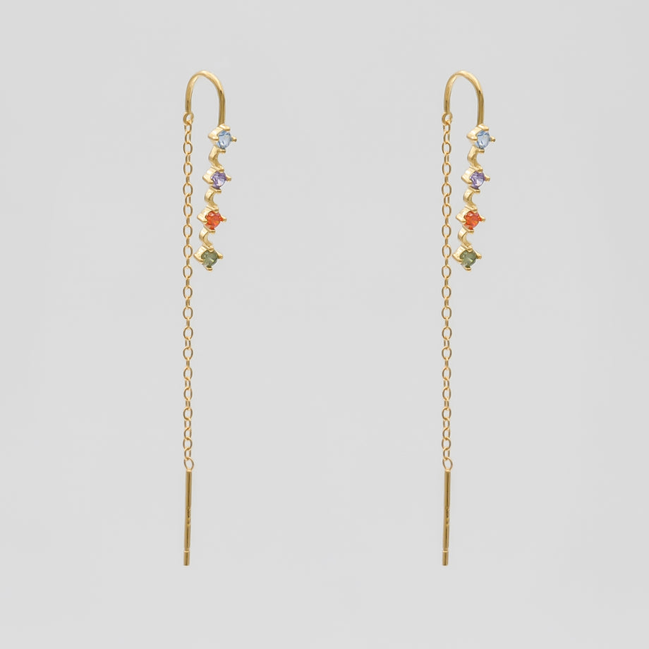 Gold threader earrings with colourful gemstones.