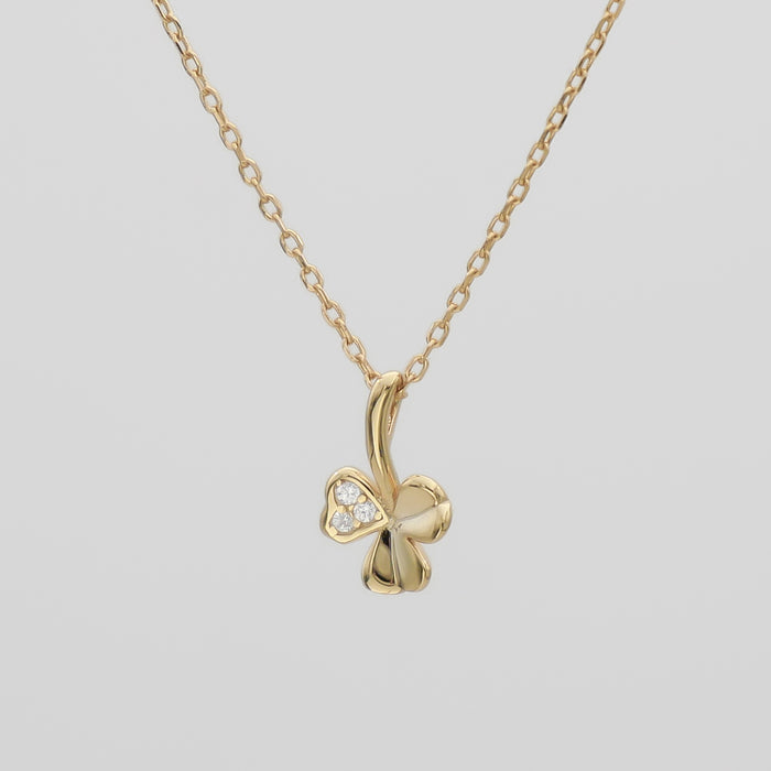 Gold clover pendant necklace with diamond accents.