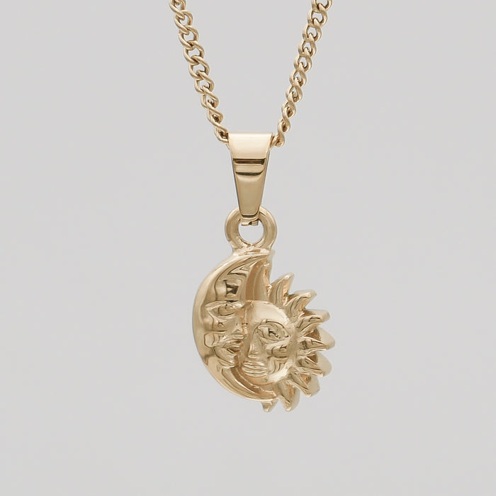 Gold sun and moon pendant necklace.