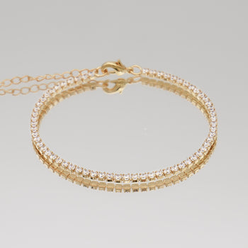 Icy tennis cz bracelet in gold plated with clear stones