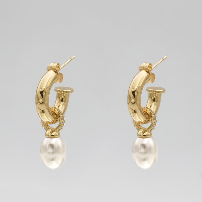 Gold hoop earrings with pearl drops.